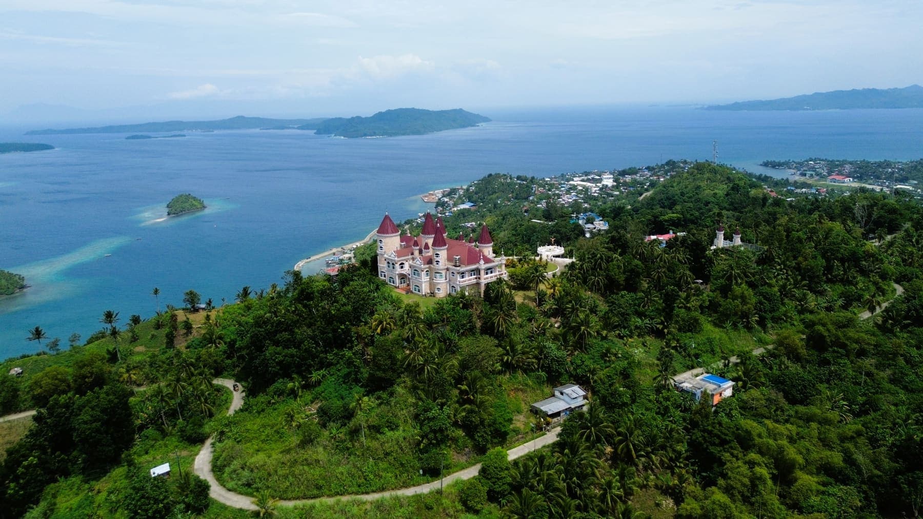 The road climbing through forested hills toward the ridge in San Jose, Dinagat Islands
